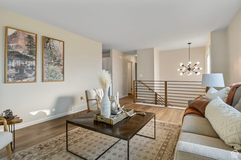 Living room featuring hardwood / wood-style floors and a notable chandelier