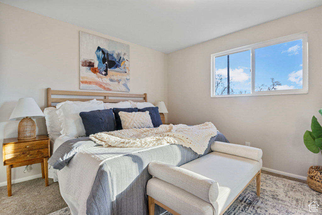 Bedroom featuring light carpet