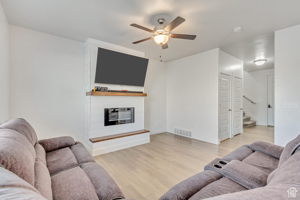 Living room with hardwood / wood-style flooring and ceiling fan