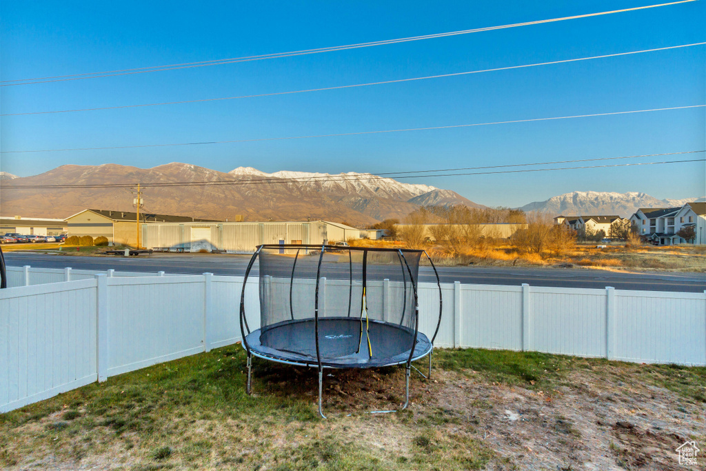 View of yard featuring a mountain view and a trampoline