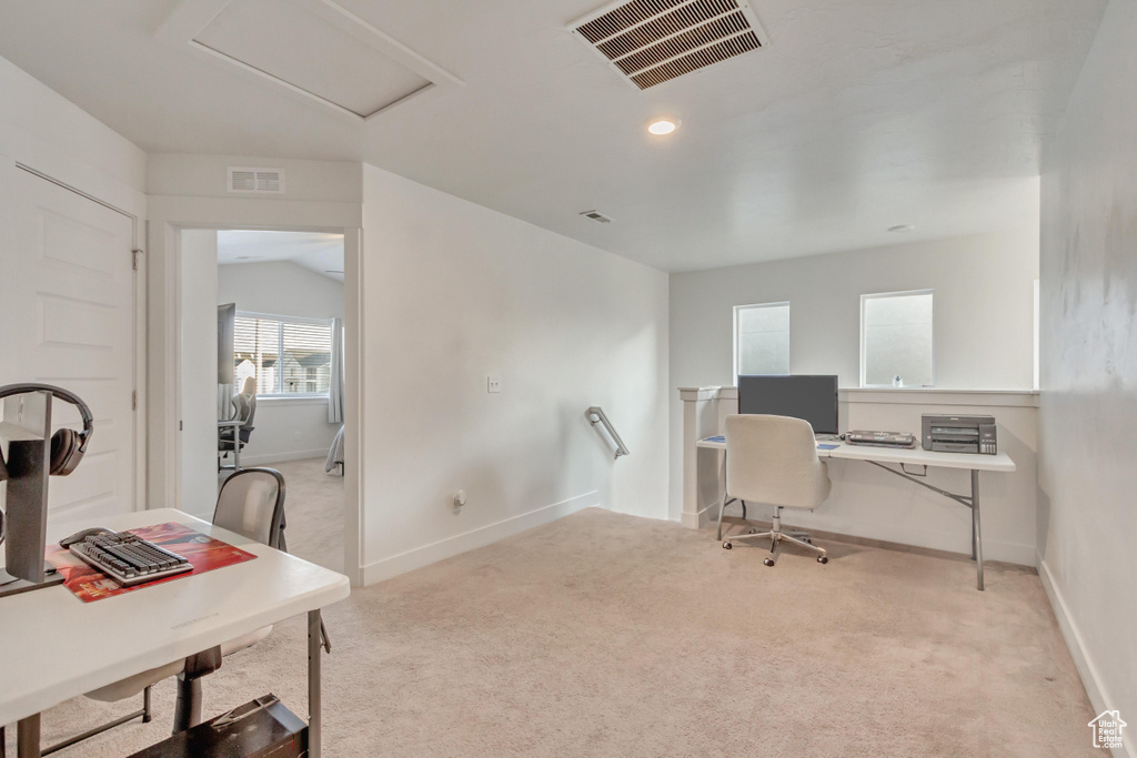 Carpeted office featuring vaulted ceiling