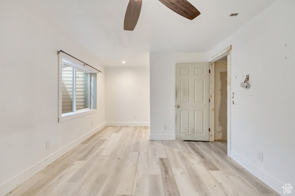 Unfurnished room featuring ceiling fan and light hardwood / wood-style flooring