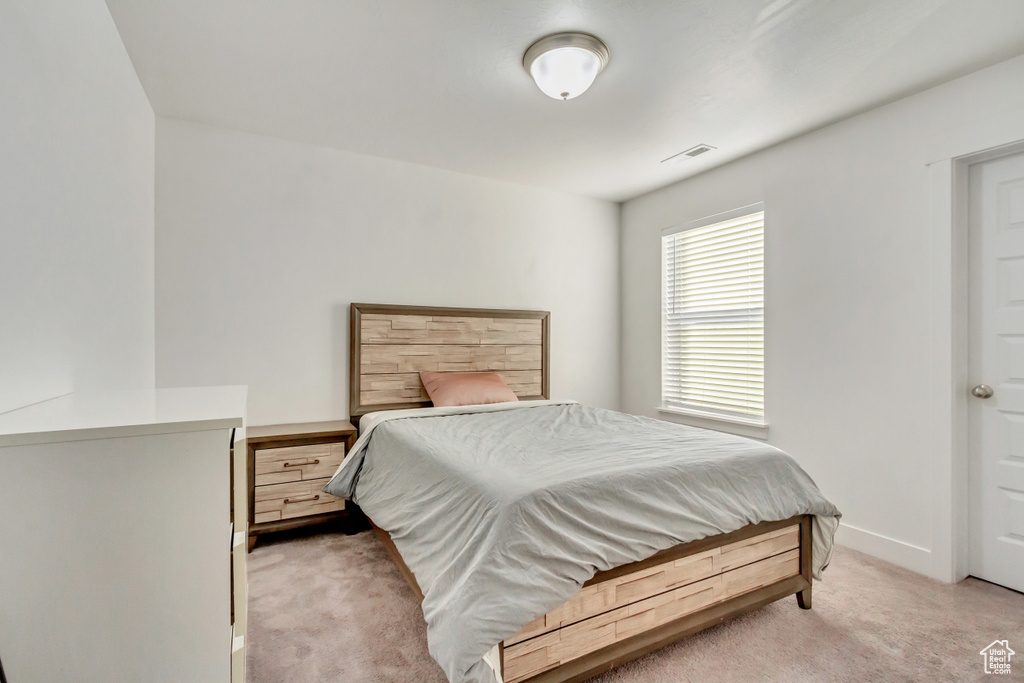 Bedroom with light colored carpet