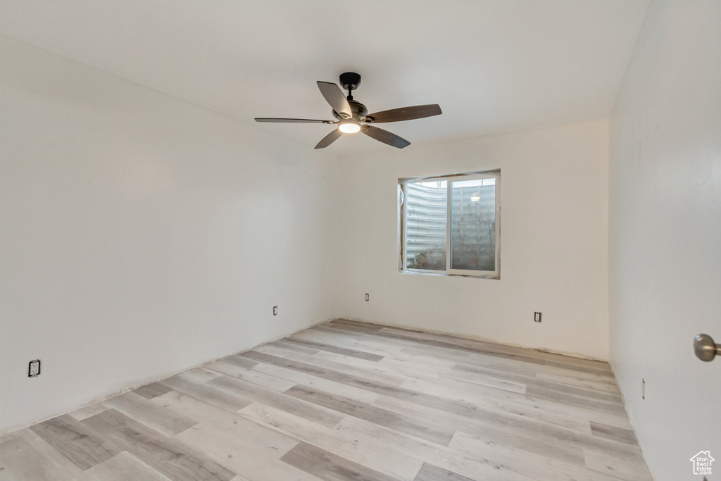 Empty room with light wood-type flooring and ceiling fan