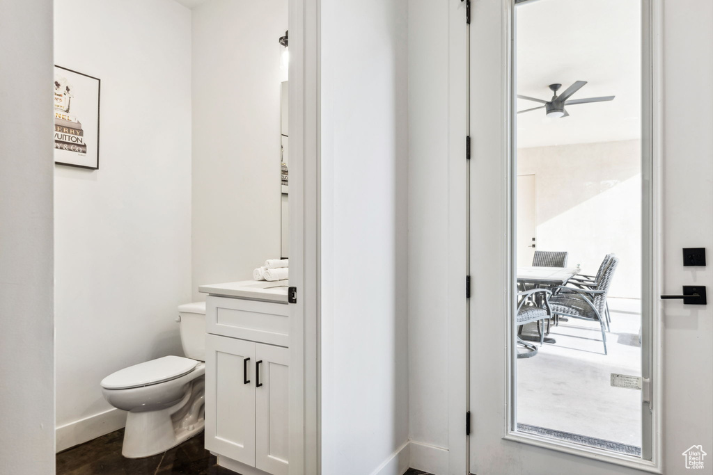 Bathroom with ceiling fan, vanity, and toilet