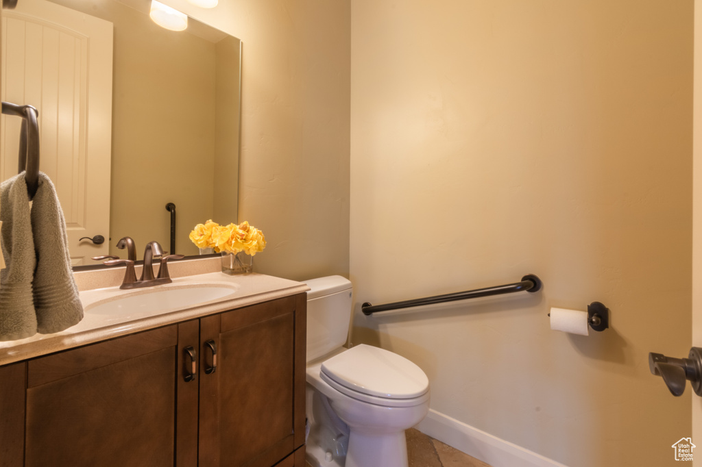 Bathroom featuring tile patterned flooring, vanity, and toilet