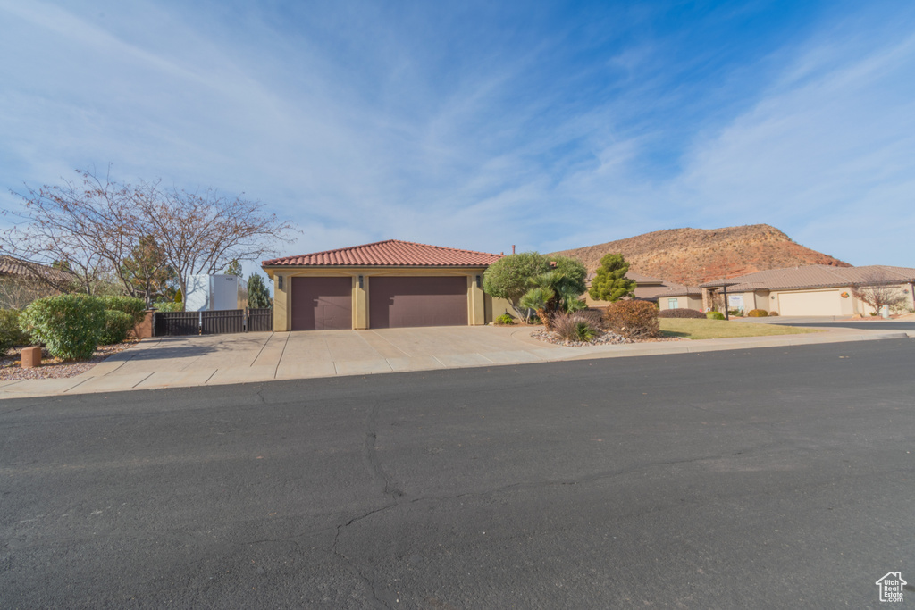 View of front of home featuring a mountain view and a garage