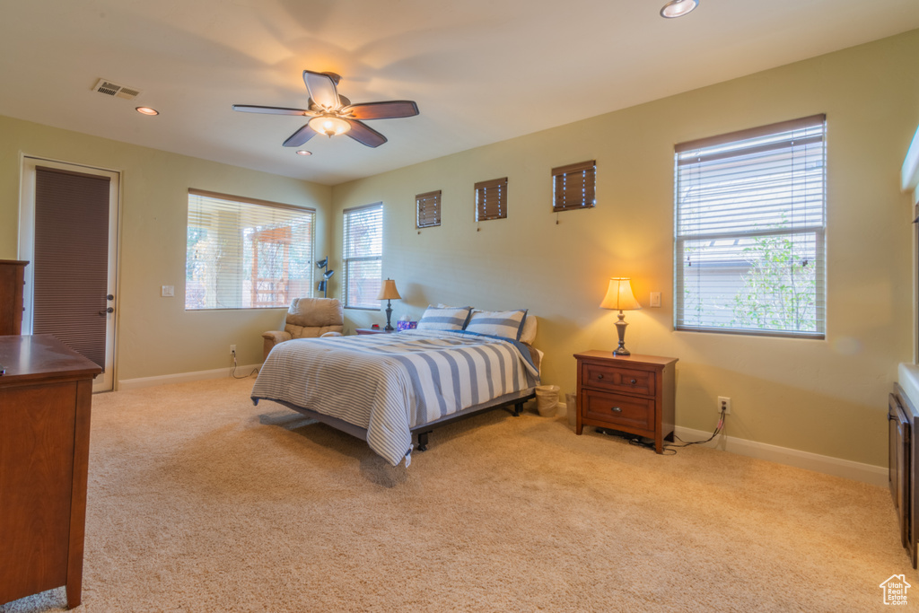 Carpeted bedroom with ceiling fan