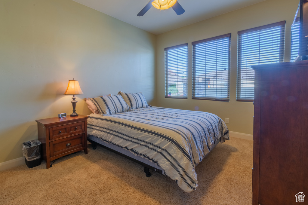 Carpeted bedroom with ceiling fan
