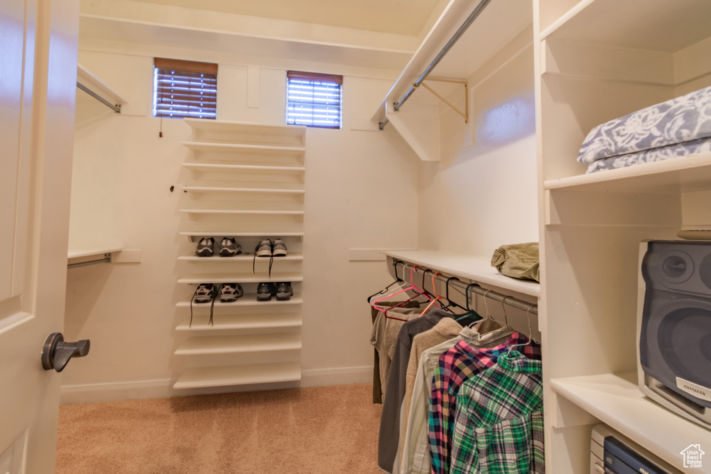 Walk in closet featuring light carpet