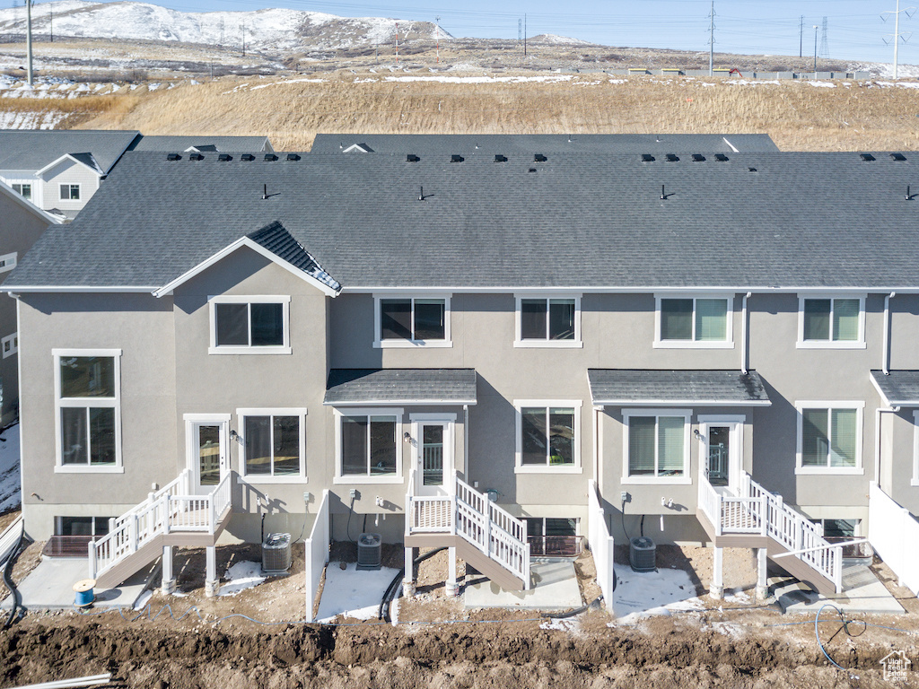 Rear view of house featuring central AC and a patio area