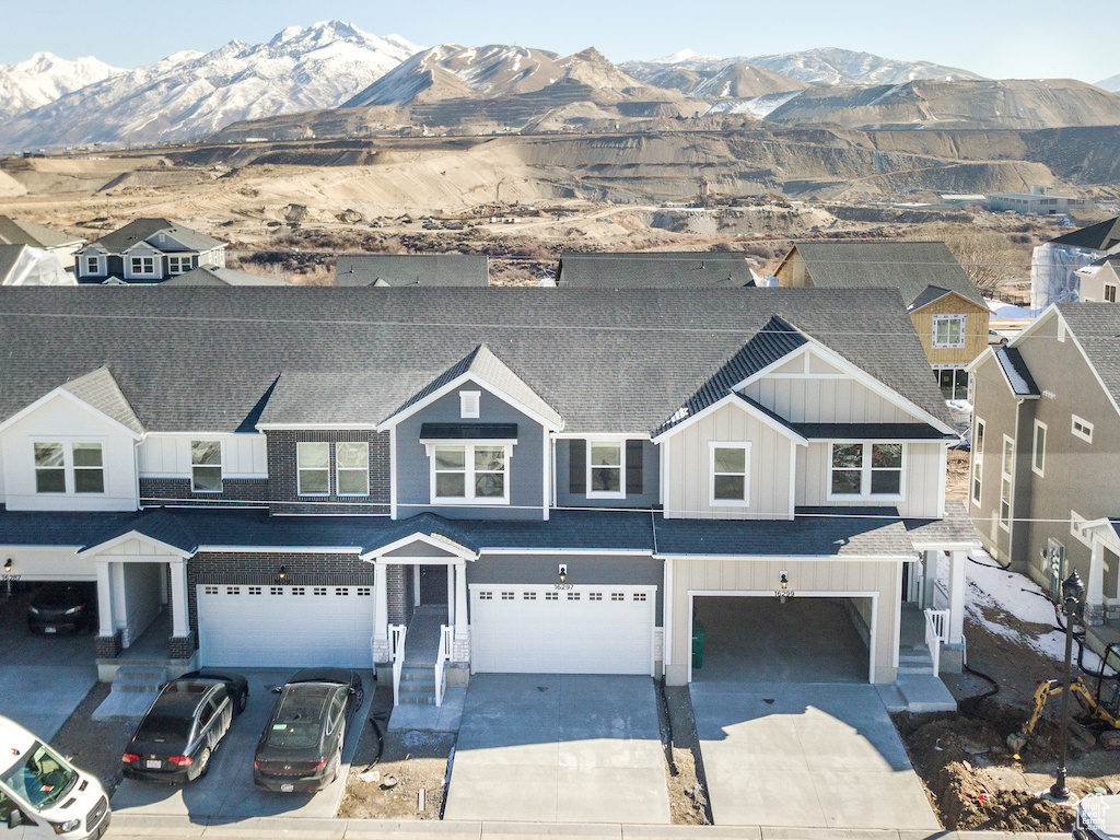 View of front of house with a garage and a mountain view