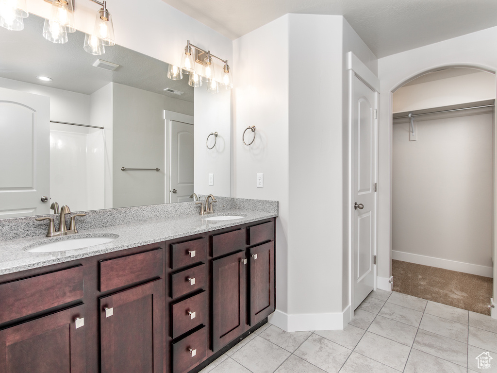 Bathroom with vanity and tile patterned floors