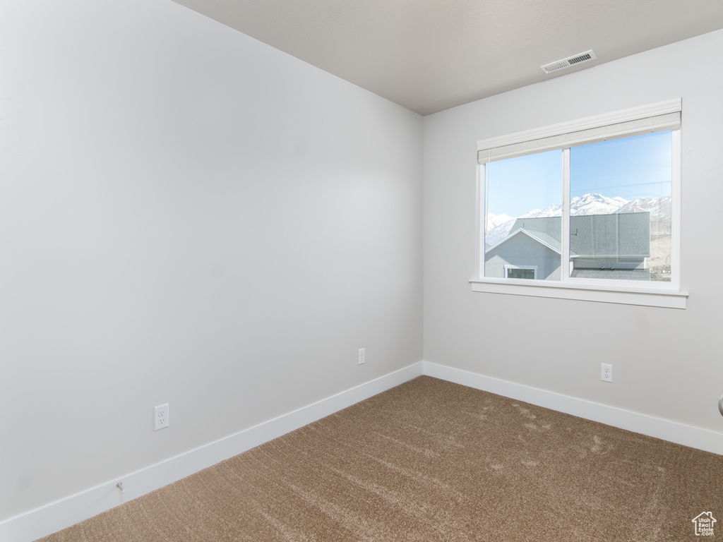 Spare room featuring carpet flooring