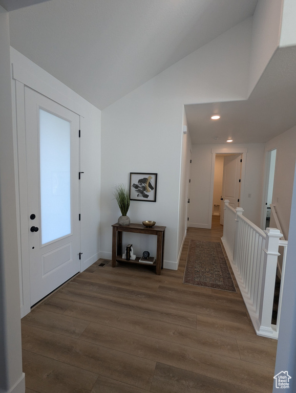 Entrance foyer featuring hardwood / wood-style floors and lofted ceiling