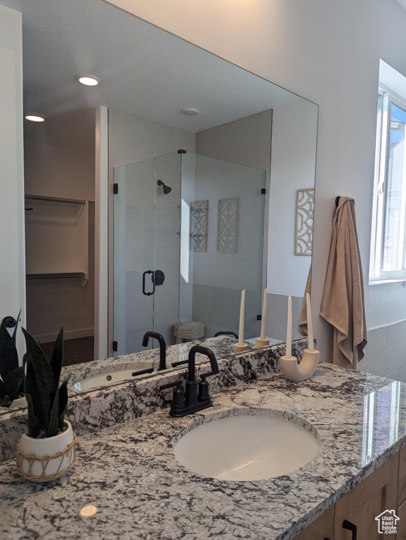 Bathroom featuring vanity, toilet, and walk in shower