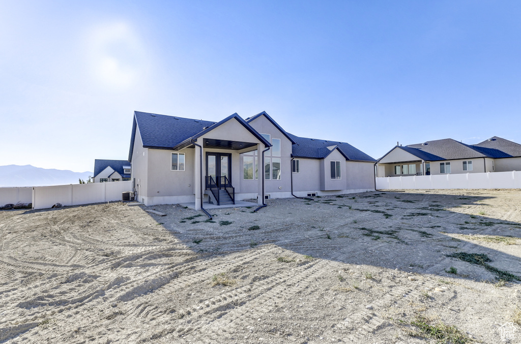 View of front of house featuring cooling unit