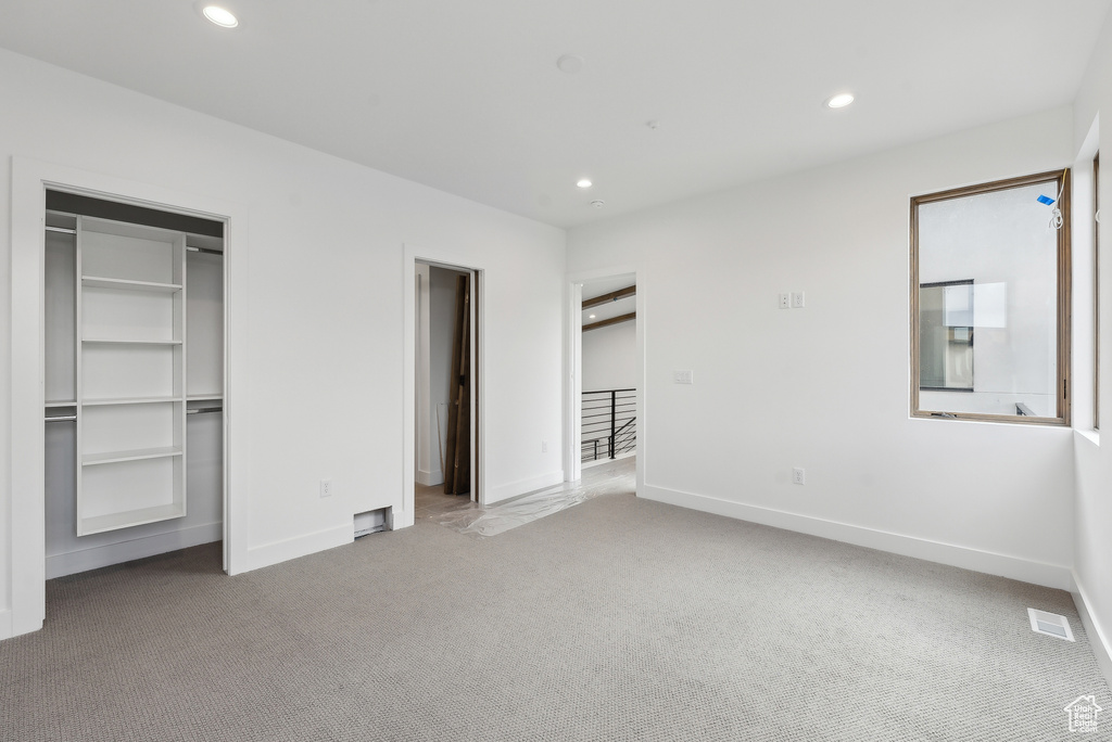 Unfurnished bedroom with carpet flooring, recessed lighting, and baseboards