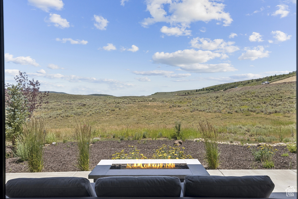 View of yard featuring an outdoor fire pit and a mountain view