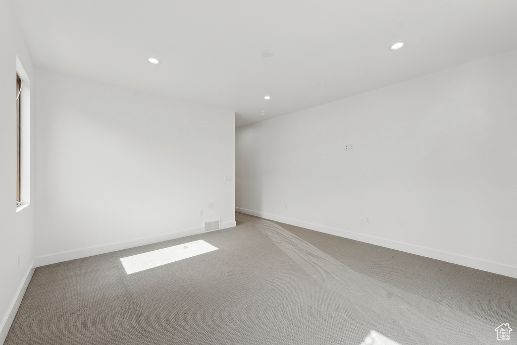 Unfurnished room with light carpet, recessed lighting, and baseboards