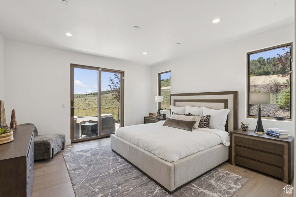 Bedroom featuring access to outside, light wood-style floors, and recessed lighting