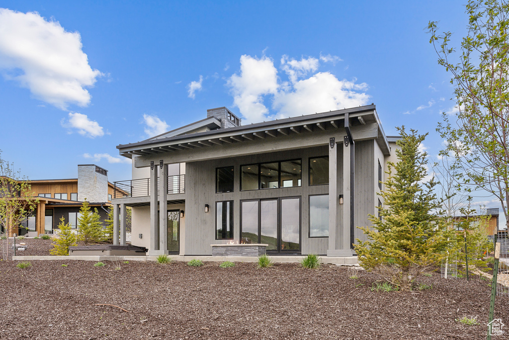 Rear view of house featuring a balcony