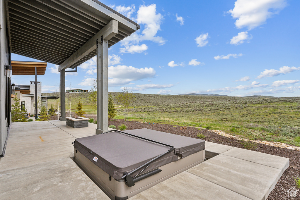 View of patio featuring a hot tub