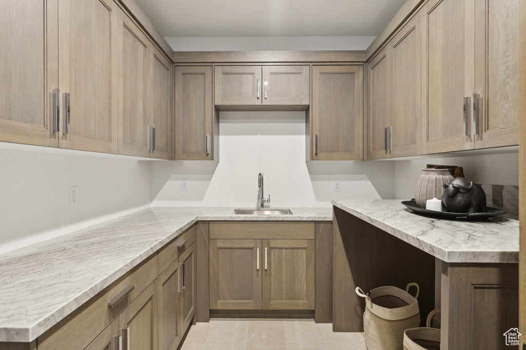 Kitchen featuring a sink and light countertops
