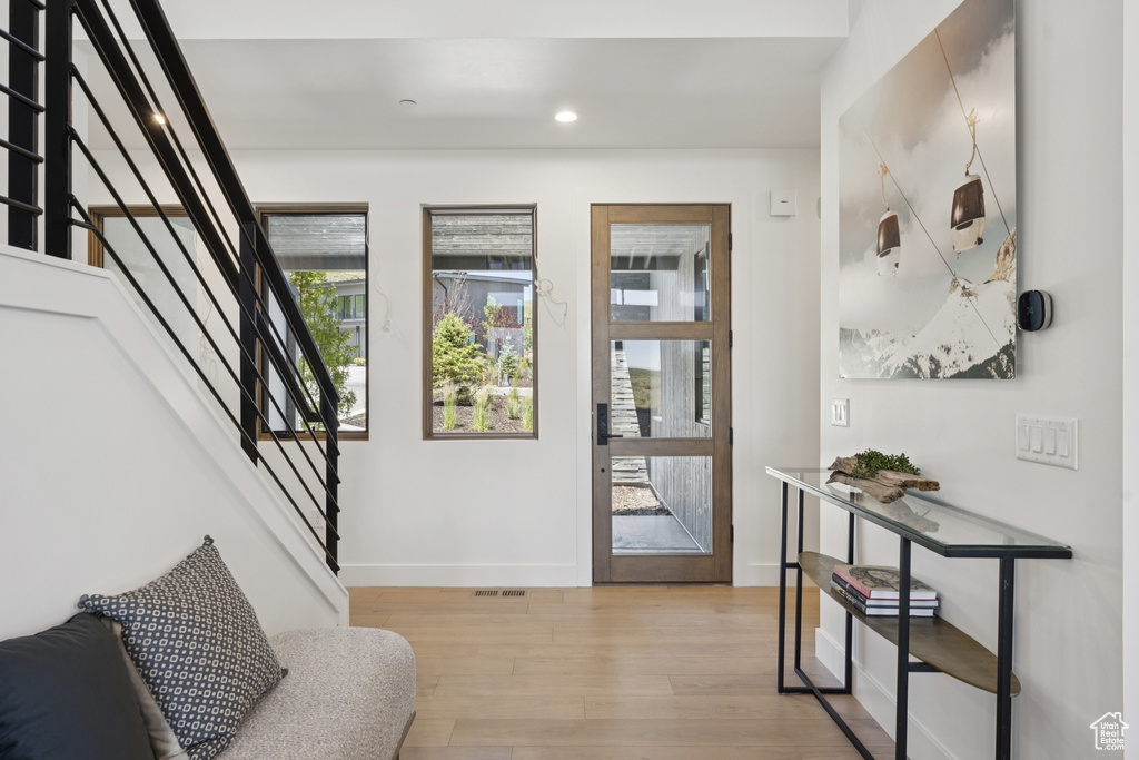 Entrance foyer featuring light wood finished floors, stairs, and recessed lighting