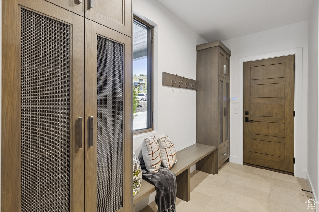 Mudroom with light tile patterned flooring