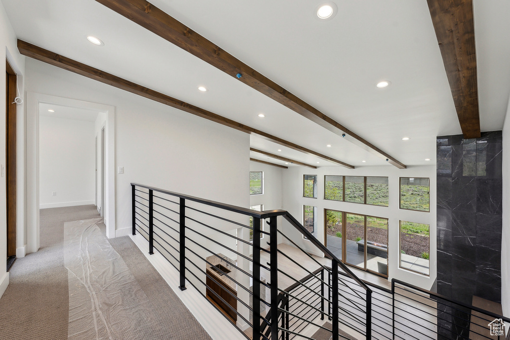 Hallway featuring recessed lighting, an upstairs landing, beamed ceiling, carpet, and baseboards