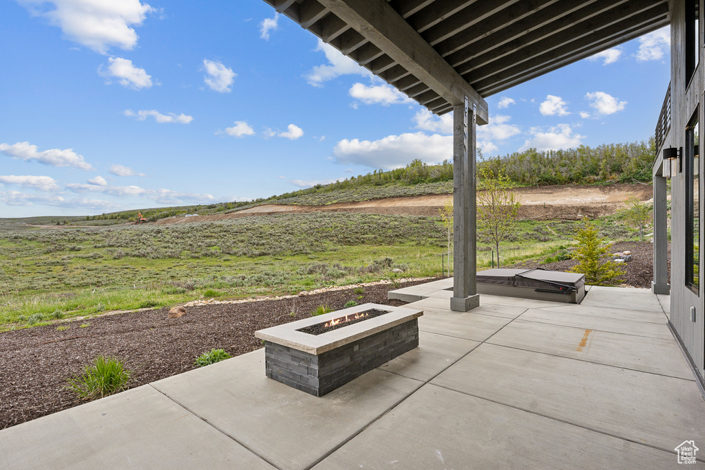 View of patio with a fire pit