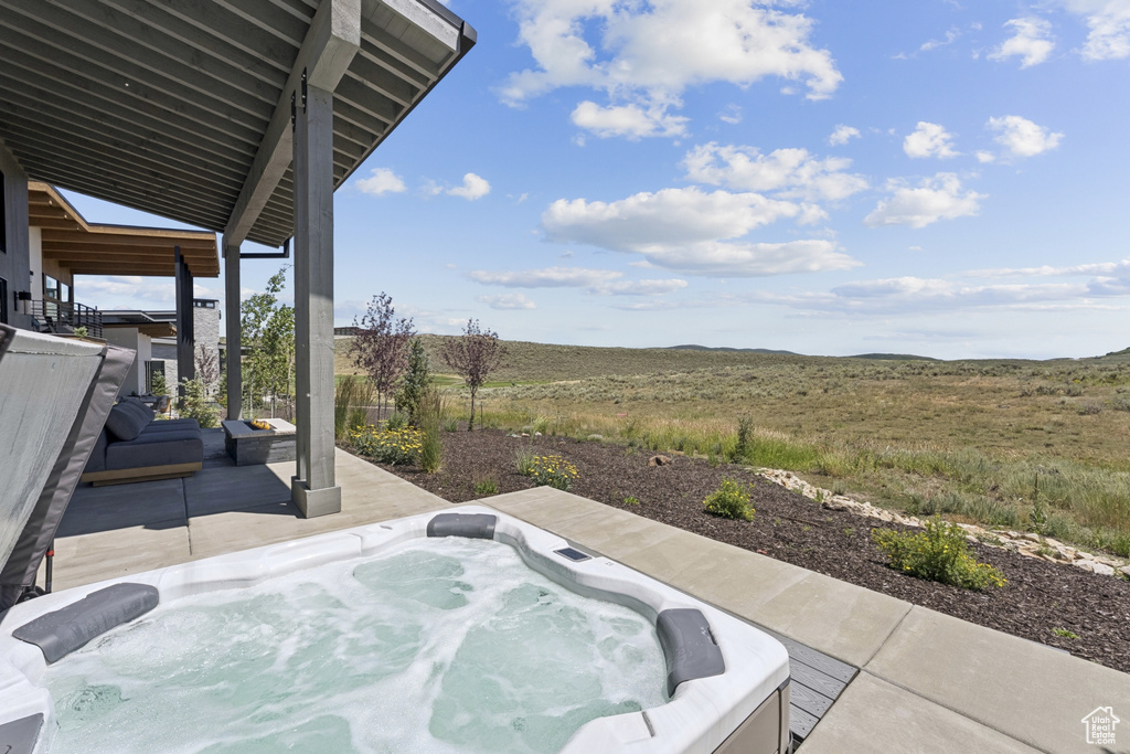 View of patio with a hot tub