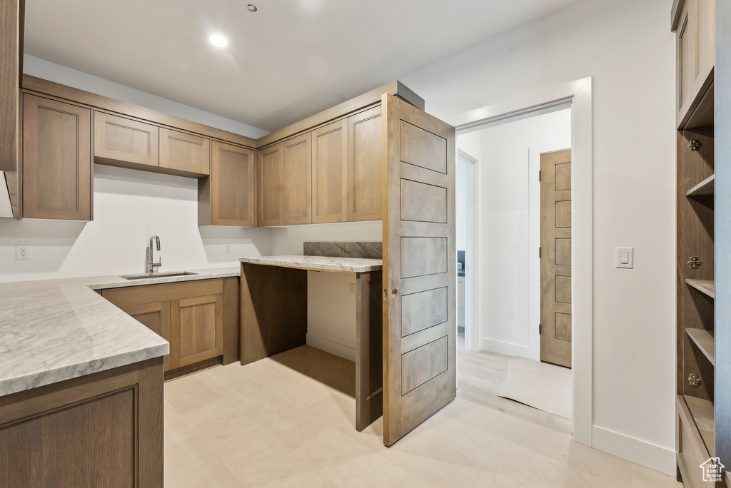 Kitchen with a sink and baseboards