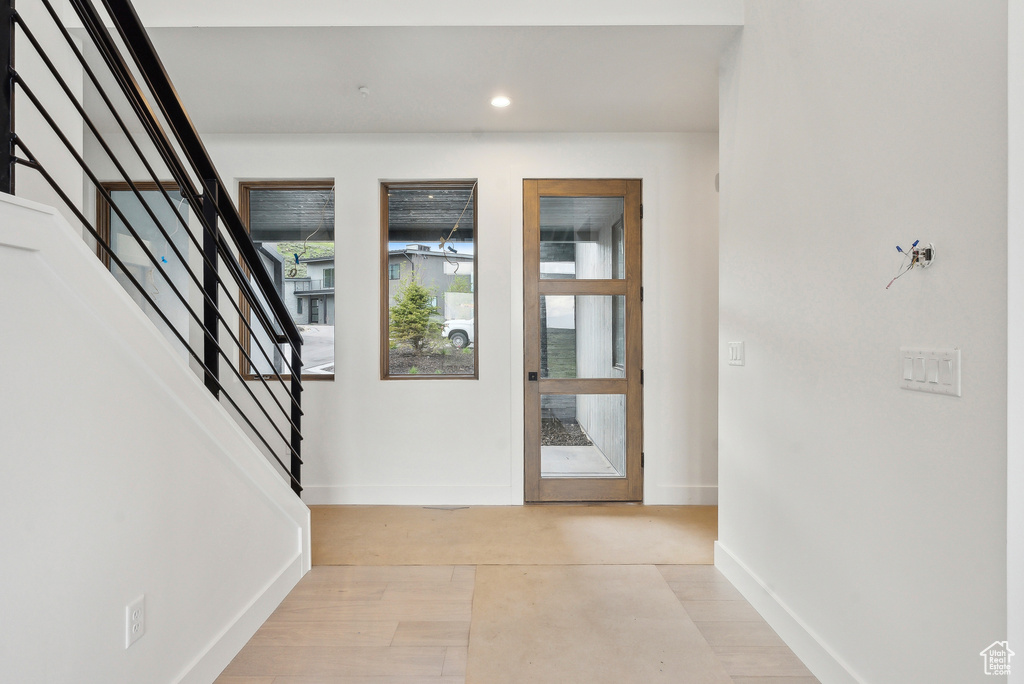 Entryway featuring stairs, baseboards, and recessed lighting