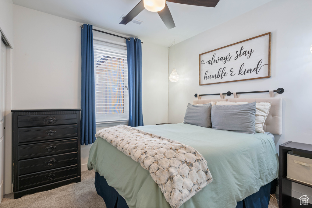 Bedroom with ceiling fan and carpet floors