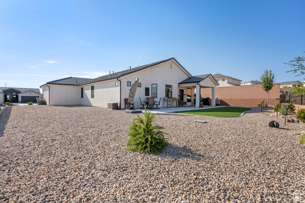 Rear view of house featuring a patio and central air condition unit