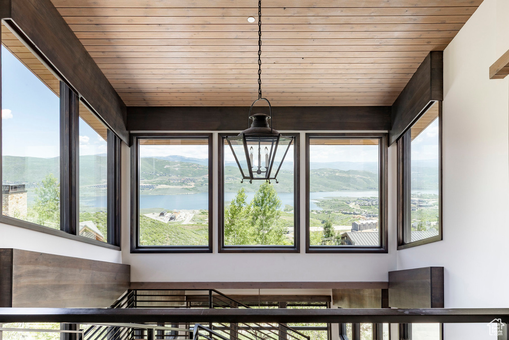 Unfurnished sunroom with plenty of natural light and a water view