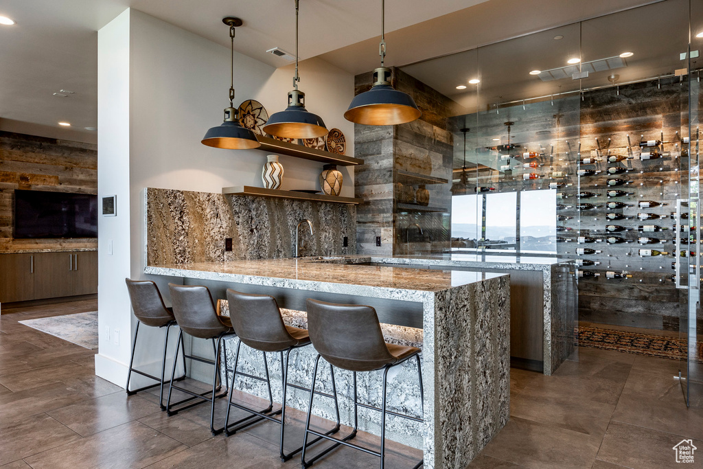 Community bar area with decorative light fixtures and recessed lighting