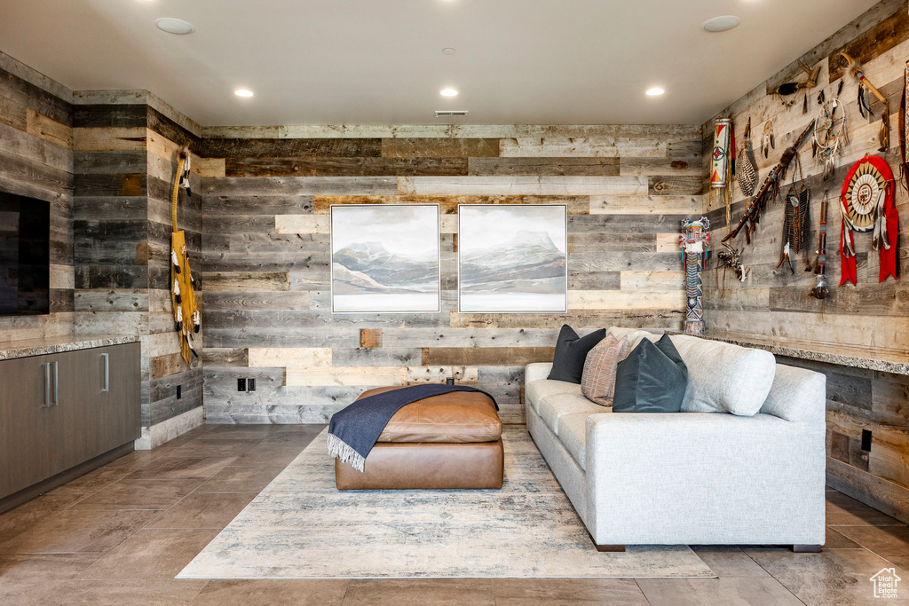 Living area with wood walls and recessed lighting
