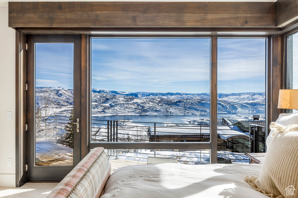 Bedroom with access to outside and a water and mountain view