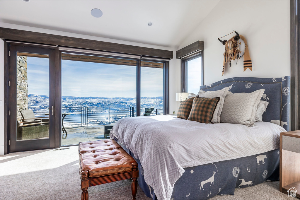 Bedroom with access to exterior, carpet flooring, and vaulted ceiling