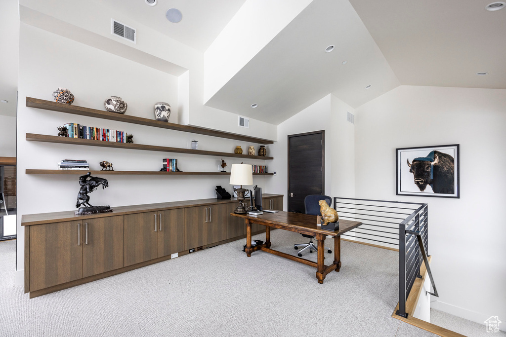Office area featuring lofted ceiling and light carpet