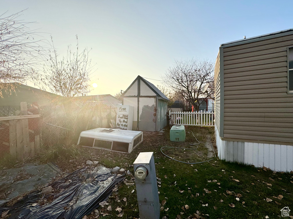 Yard at dusk with a storage shed