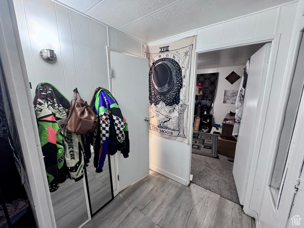 Laundry area with light wood-type flooring