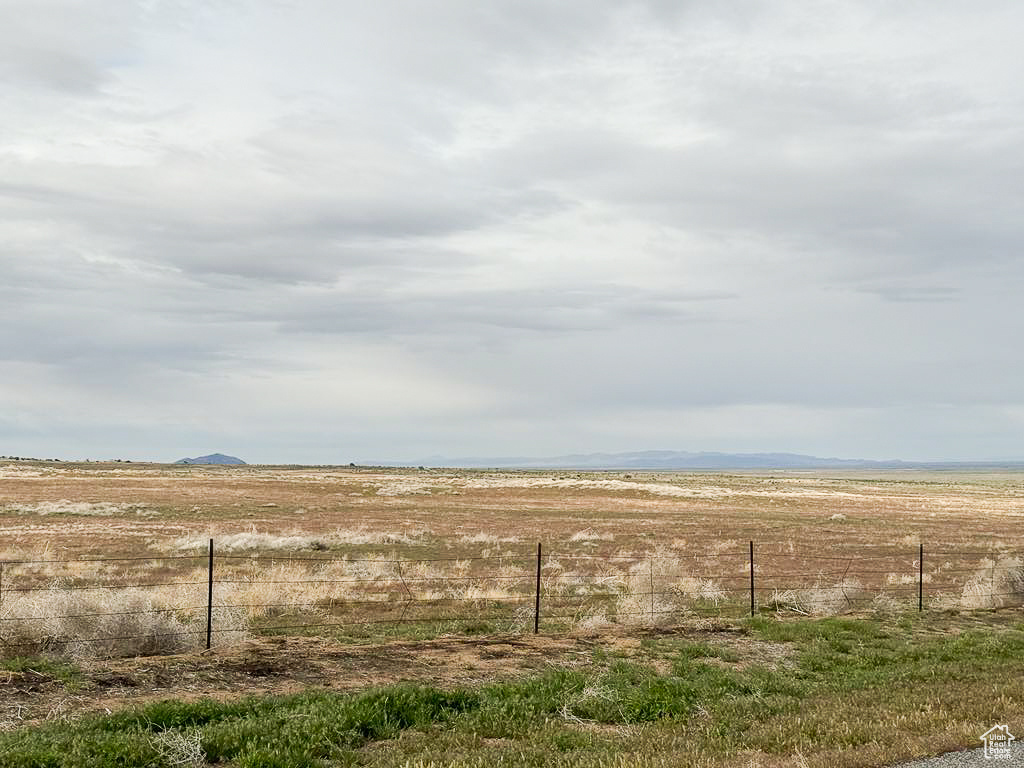 View of yard featuring a rural view and fence