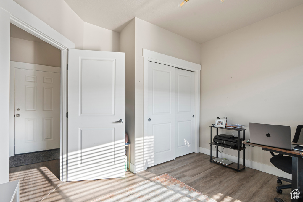 Home office with hardwood / wood-style flooring