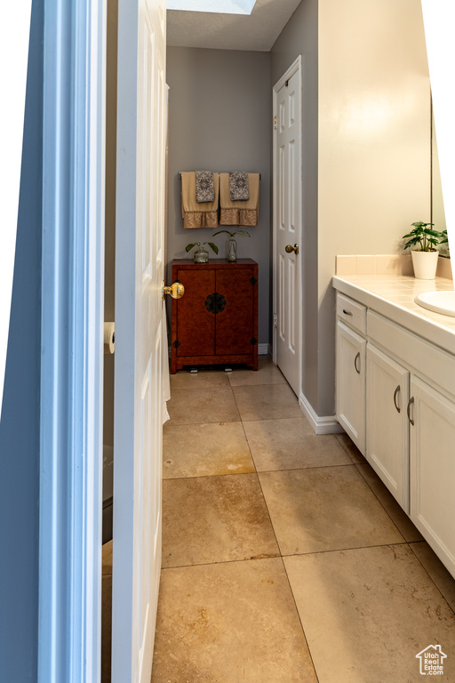 Bathroom featuring a skylight and vanity