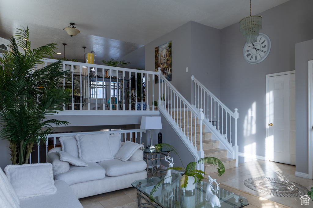 Tiled living room featuring a notable chandelier
