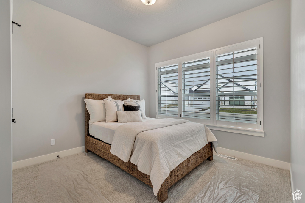 Bedroom featuring visible vents, carpet, and baseboards